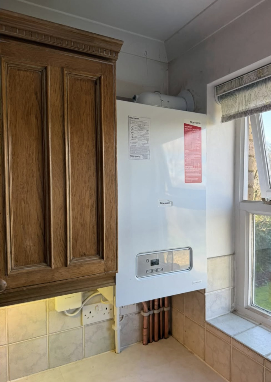 New Glow-worm combi boiler installed in a kitchen alcove, replacing an old Potterton Suprima