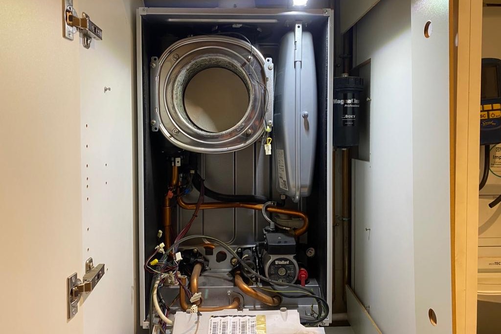 Gas Safe engineer servicing a boiler control panel